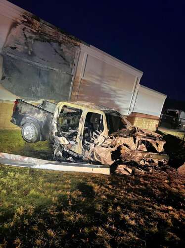 Driver charged after pickup truck slams into building, bursts into flames