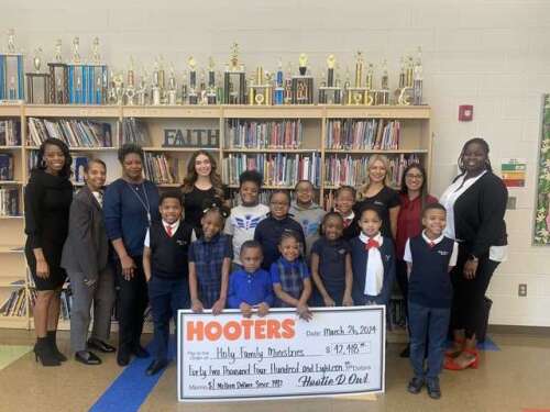 Hooters presents $42,418 donation to Holy Family School, Chicago - Vimarsana News