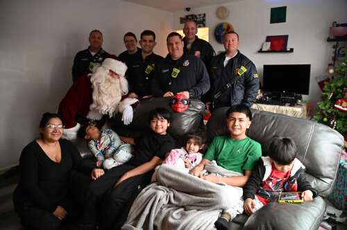 On Christmas morning, 11-year-old Cande Rufino was at the window of his Elgin apartment on the lookout for Santa — arriving by fire truck instead of the traditional sleigh. Each year, firefighters d...