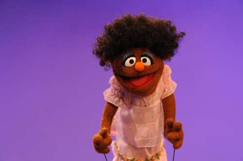 Curly haired Muppet becomes a role model