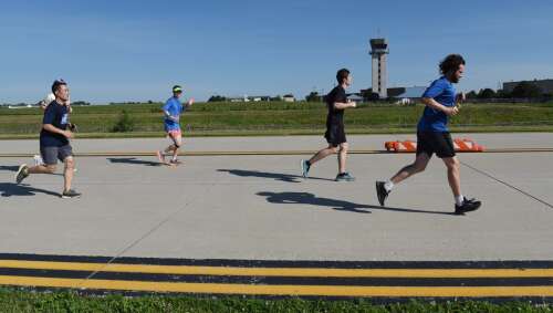 Runners fly to the finish during airport 5K