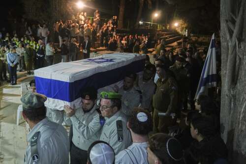 As dispute over hostages' bodies tests ceasefire, Israelis bury their dead