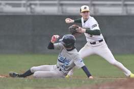 Elk Grove’s Miles Schwartz forces out Plainfield South’s Nick Ruenzi at second base as he tries for a double play in a baseball game in Elk Grove Village on Monday, March 25, 2024.