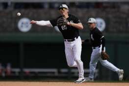 Chicago White Sox shortstop Colson Montgomery throws to first to out San Diego Padres' Óscar Mercado during the fourth inning of a spring training baseball game in Phoenix, Wednesday, Feb. 28, 2024. (AP Photo/Ashley Landis)