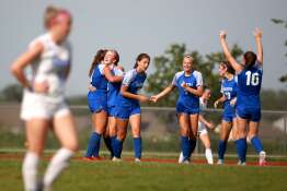 Wheaton North players celebrate a goal by Jane Rogers during a Class 3A South Elgin Sectional semifinal game against Geneva on Tuesday, May 21, 2024.