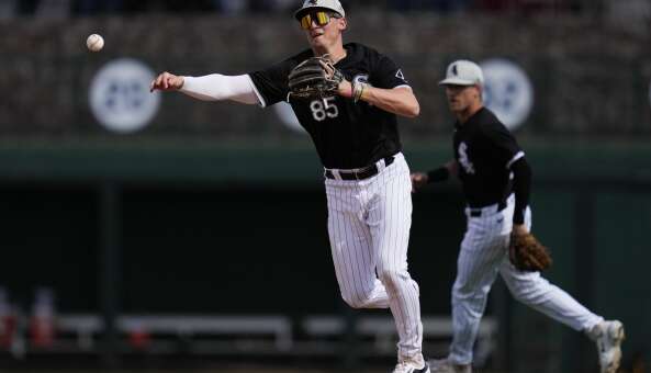 Chicago White Sox shortstop Colson Montgomery throws to first to out San Diego Padres' Óscar Mercado during the fourth inning of a spring training baseball game in Phoenix, Wednesday, Feb. 28, 2024. (AP Photo/Ashley Landis)