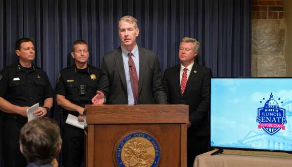 Senate Republican Leader John Curran discusses his legislation that would make fleeing from police in a vehicle a felony. With him, from left, are Lemont Police Chief Marc Maton, Naperville Police Chief Jason Arres and state Sen. Seth Lewis.