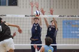St. Viator’s Kevin Doherty, left, and Adrien Ruzic go for the block against Joliet Catholic on Wednesday, April 24, 2024 in Joliet.