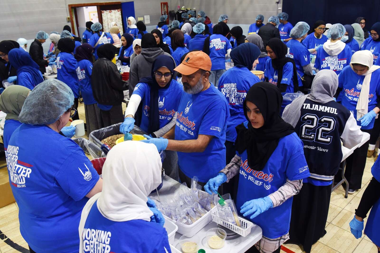 Volunteers participate in the Islamic Relief USA meal packing event at College Preparatory School of America on Saturday in Lombard. Joe Lewnard/jlewnard@dailyherald.com