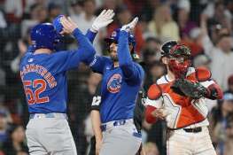 The Cubs' Mike Tauchman, center, celebrates after his three-run home run that also drove in Pete Crow-Armstrong (52) in the eighth inning of Sunday’s 5-4 loss to the Red Sox in Boston.