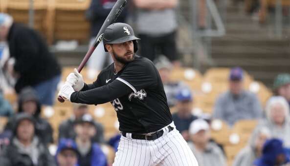 Chicago White Sox's Paul DeJong starts his swing during the second inning of a spring training baseball game against the Chicago Cubs Friday, March 15, 2024, in Phoenix. (AP Photo/Ross D. Franklin)