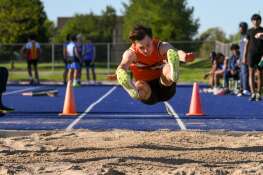 Logan Ehlers of Kaneland competes in the long jump during the Kane County track and field meet held at Marmion Academy in Aurora on Friday May 3, 2024.
