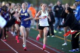 St. Charles East’s Marley Andelman leads the 800-meter run during the 2024 Kane County Girls Track and Field meet at St. Charles East on Thursday, April 25, 2024.