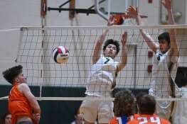Fremd’s Alex Ma, middle, and AJ Messner, right, block a ball hit by Buffalo Grove’s Brandon Pelts during a semifinal match of the Fremd boys volleyball tournament on Saturday, May 4, 2024 in Palatine.