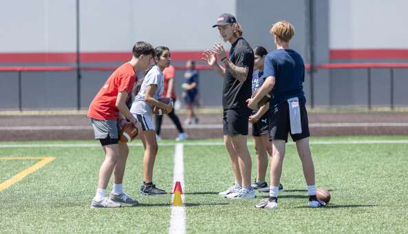 Bears backup quarterback Tyson Bagent shares quarterbacking tips with teenagers Sunday at the TB17 QB Workout, a free youth activity at Nicholas Sportsplex in Mount Prospect.