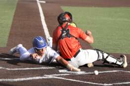 Geneva’s Joey Cosentino slides safely into home plate as St. Charles East catcher Mac Paul attempts the out during a game at Judson University in Elgin on Tuesday, May 7, 2024.