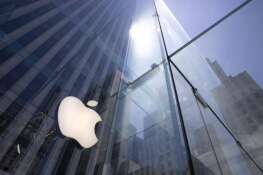 FILE — In this June 16, 2020 file photo, the sun is reflected on Apple's Fifth Avenue store in New York.