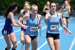 Prospect’s Meg Peterson, left, takes the baton from Lily Ginsberg in the 3,200-meter relay during the Class 3A girls state track and field finals on Saturday, May 18, 2024 in Charleston.