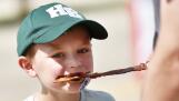 Ryan Oswald, 6, of Hoffman Estates bites into chocolate covered bacon Saturday during the Long Grove Chocolate Fest. Ryan was at the fest with his family.