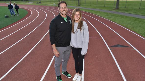 York High School assistant girls track coach Niko Karavolos poses with athlete Chloe Peot on Friday, May 10, 2024.