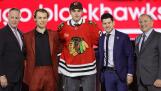 Artyom Levshunov, center, poses after being selected by the Chicago Blackhawks during the first round of the NHL hockey draft Friday, June 28, 2024, in Las Vegas. (AP Photo/Steve Marcus)