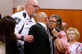 Carlos Acosta tries to kiss his wife, Lori, as he is taken into custody on Thursday after Lake County Judge George Strickland sentenced Acosta to six months in jail and 30 months of probation.