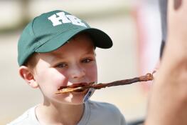 Ryan Oswald, 6, of Hoffman Estates bites into chocolate covered bacon Saturday during the Long Grove Chocolate Fest. Ryan was at the fest with his family.