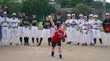 Nine-year-old Casey Siebrass throws out the first pitch during opening night of the 20th year of the Casey Pohl Memorial Tournament Thursday in Palatine. The youth baseball tournament is hugely popular drawing thousands of attendees.