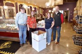 Chocolaterie Stam in Glen Ellyn has a large donation bin to collect food for the College of DuPage Fuel Pantry. From left are Paul Keenon, Rotary Assistant Governor; Rotary board member Erika Krehbiel, chief communications officer for Glen Ellyn School District 41; Liz Mager, owner of Chocolaterie Stam and the club’s past president; and Rob Wilkinson, B.R. Ryall YMCA CEO and president of the Glen Ellyn Rotary Club.