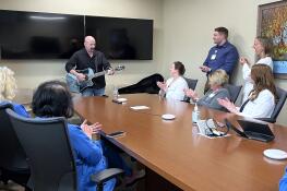 Hi Infidelity singer Dave Mikulskis of Wheaton performs an impromptu mini-concert for his medical team, including Dr. Martha McGraw, next to Mikulskis on the right, after an appointment at Northwestern Medicine Central DuPage Hospital in Winfield.