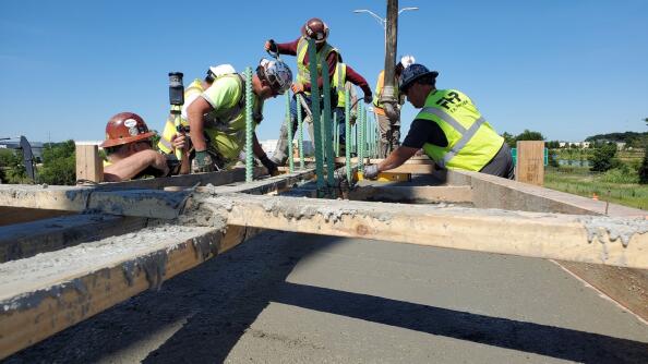 Crews work on the Interstate 355 construction project. Concrete’s main binding ingredient, cement, represents a whopping 7% to 8% of global carbon emissions.