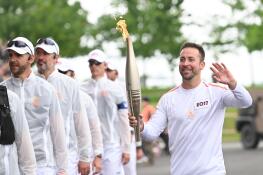 Danny Bruno, who attended Fremd High School in Palatine, runs his 200-meter portion of the Olympic torch relay in the town of Saint-Maixent L’ Ecole, just outside Poitiers, France.
