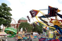 Carnival riders fly through the air on Wednesday during the opening day of Swedish Days in Geneva.
