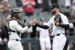 Chicago White Sox catcher Korey Lee and relief pitcher Justin Anderson celebrate the team's 11-3 win over the Colorado Rockies following a baseball game Saturday, June 29, 2024, in Chicago. (AP Photo/Charles Rex Arbogast)