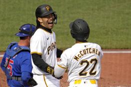 Pittsburgh Pirates' Connor Joe, center, celebrates with Andrew McCutchen (22) after hitting a three-run home run off Chicago Cubs starting pitcher Justin Steele during the third inning of a baseball game in Pittsburgh, Saturday, May 11, 2024. (AP Photo/Gene J. Puskar)