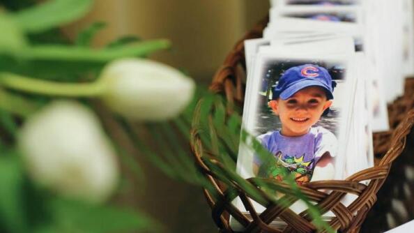 Prayer cards for AJ Freund, 5, sit on a table next to the visitor guest book on May 3, 2019, during a memorial service at Davenport Funeral Home in Crystal Lake.