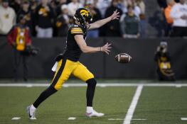 Iowa punter Tory Taylor punts during the second half of an NCAA college football game against Illinois, Saturday, Nov. 18, 2023, in Iowa City, Iowa. Iowa won 15-13. (AP Photo/Charlie Neibergall)
