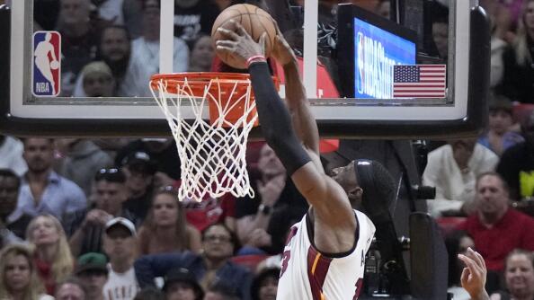 Miami Heat center Bam Adebayo (13) dunks the ball against Chicago Bulls center Nikola Vucevic (9) and guard Coby White (0) during the second half of an NBA basketball play-in tournament game, Friday, April 19, 2024, in Miami. (AP Photo/Wilfredo Lee)