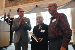 Schaumburg Mayor Tom Dailly, left, congratulates Sandy and Tony Meo, winners of the village’s Volunteer of the Year Award in the adult category. The couple, which has volunteered for decades at Spring Valley Nature Center, were honored Tuesday during the 36th annual awards luncheon.