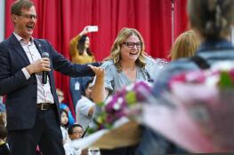Adlai Stevenson Elementary School’s Julianne Collier, right, received a Golden Apple Award for Excellence in Teaching during a surprise assembly at the school Monday. Golden Apple Foundation President Alan Mather, left, made the announcement.
