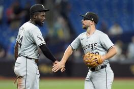 Chicago White Sox shortstop Paul DeJong (29) celebrates with third baseman Bryan Ramos (44) after the team defeated the Tampa Bay Rays during a baseball game Wednesday, May 8, 2024, in St. Petersburg, Fla. (AP Photo/Chris O'Meara)