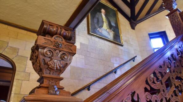 A craftsman took 15 months to restore the walnut staircase in Mayslake Hall in Oak Brook. A portrait of Chicago industrialist Francis Stuyvesant Peabody hangs in the stairway. He commissioned the mansion’s construction from 1919 to 1921.