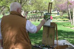 A Prairie Plein Air art competition participant paints on the grounds of the village of Schaumburg's Robert O. Atcher Municipal Center.
