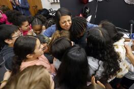 Fifth grade Georgetown Elementary School teacher Rachael Mahmood is surrounded by her students Thursday after she was surprised by the Illinois State Board of Education with the Illinois Teacher of the Year Award.