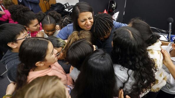 Fifth grade Georgetown Elementary School teacher Rachael Mahmood is surrounded by her students Thursday after she was surprised by the Illinois State Board of Education with the Illinois Teacher of the Year Award.
