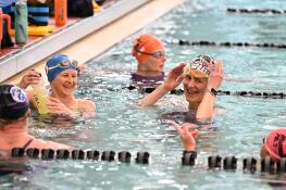 Katie Thatcher of Streamwood, facing at left, and Traci Pickerell of Elgin, center right, talk with teammates from the Elgin Blue Wave Masters Swim Club during a recent practice.