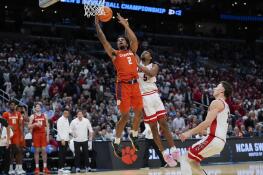 Clemson guard Dillon Hunter (2) scores past Arizona guard KJ Lewis (5) during the second half of a Sweet Sixteen college basketball game in the NCAA tournament Thursday, March 28, 2024, in Los Angeles. (AP Photo/Ryan Sun)