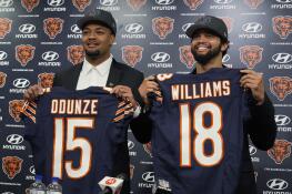 Chicago Bears No. 9 draft pick wide receiver Rome Odunze, left, and No. 1 draft pick quarterback Caleb Williams, right, hold up jerseys as they pose for a photo during an NFL football news conference in Lake Forest, Ill., Friday, April 26, 2024. (AP Photo/Nam Y. Huh)