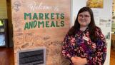 Museum curator Jessica Meis is shown at the “Markets and Meals: Batavia Goes Grocery Shopping” exhibit at the Batavia Depot Museum, on display through July 21.
