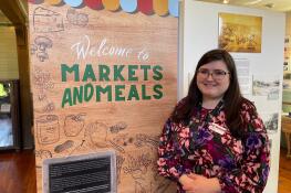 Museum curator Jessica Meis is shown at the “Markets and Meals: Batavia Goes Grocery Shopping” exhibit at the Batavia Depot Museum, on display through July 21.